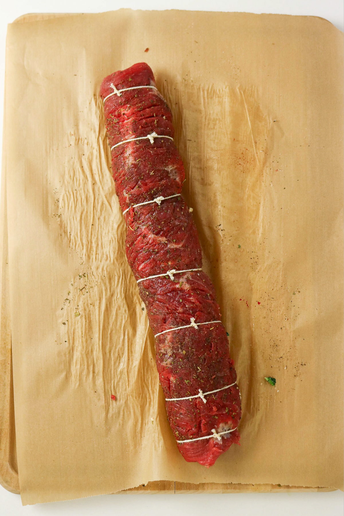 Rolled flank steak and tied to hold together before cooking.