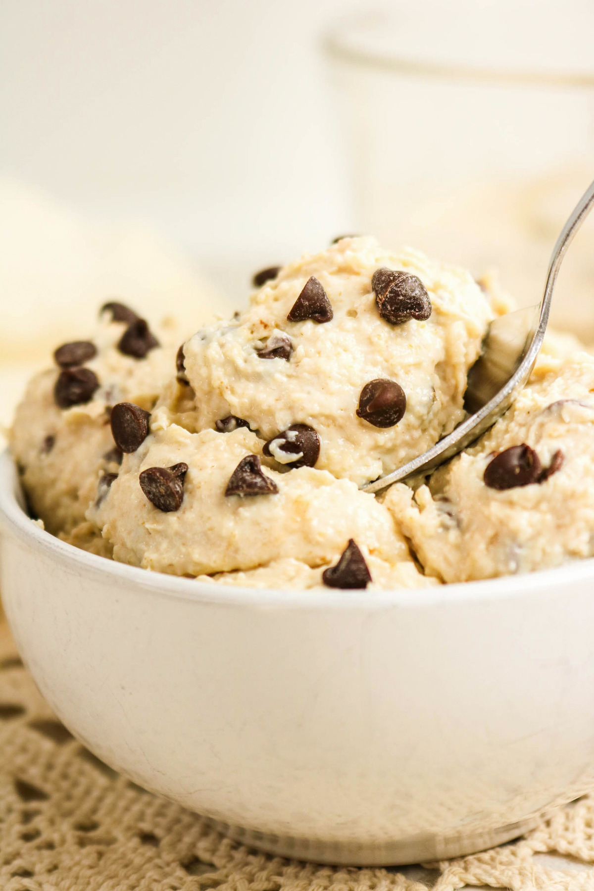 A white bowl with eatable cookie dough made with cottage cheese.