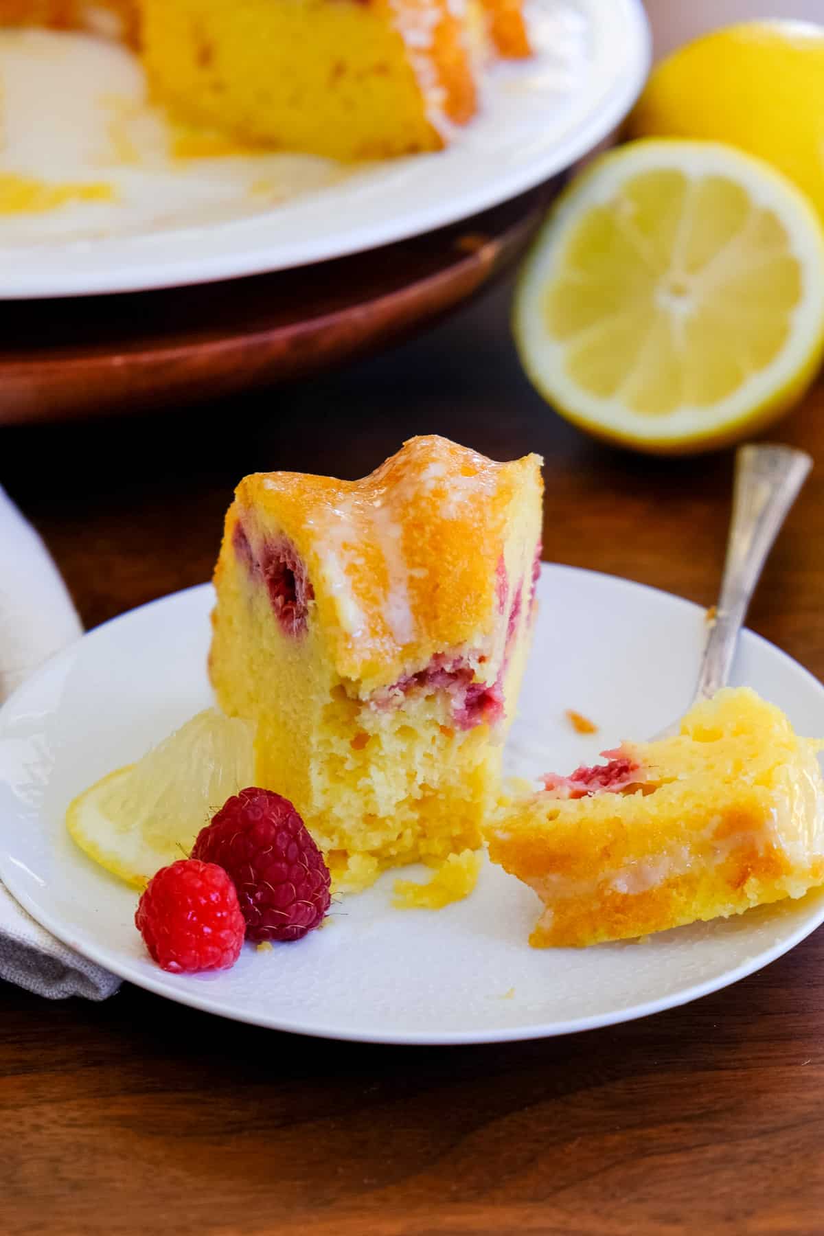 A front view of bundt cake baked with fresh raspberries.