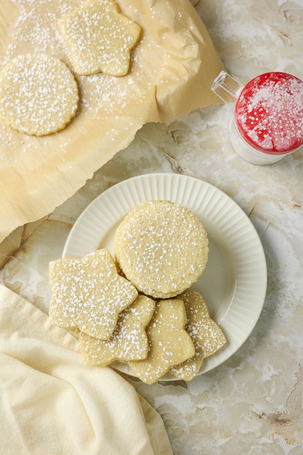 Cutout sugar cookies stacked on a plate.