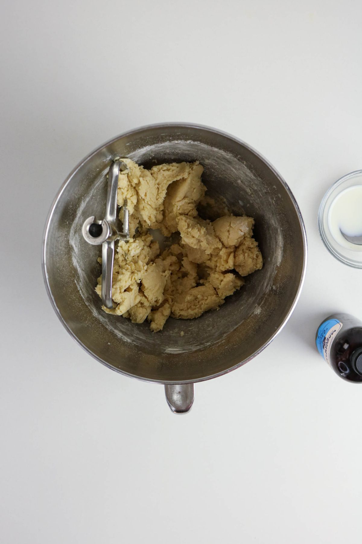 Dry ingredients being added to wet ingredients in a stand mixer.