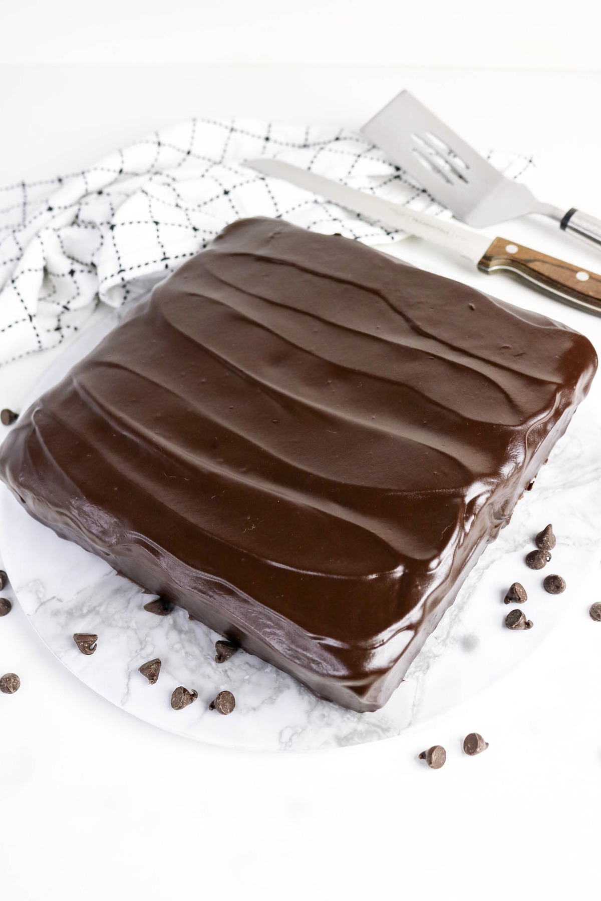 Chocolate cake with yogurt with chocolate frosting on a serving plate.