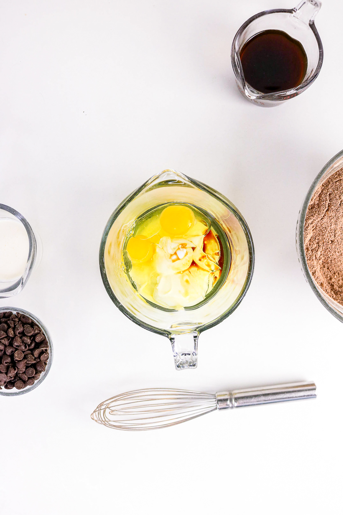Wet ingredients; eggs, yogurt for chocolate cake in a measuring cup before whisking together
