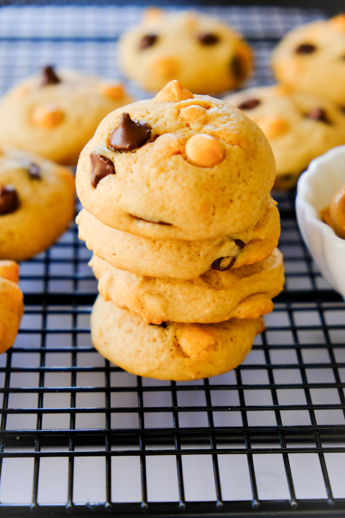 A tower of fresh baked cookies on a cooling rack.