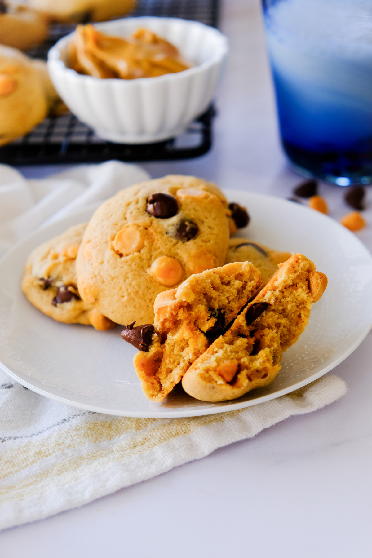 A plate with cookies with one cookie split in half.