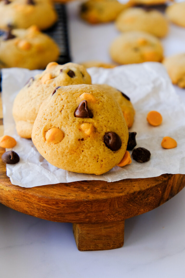 Homemade chocolate chip peanut butter chip cookies on a wooden stand.