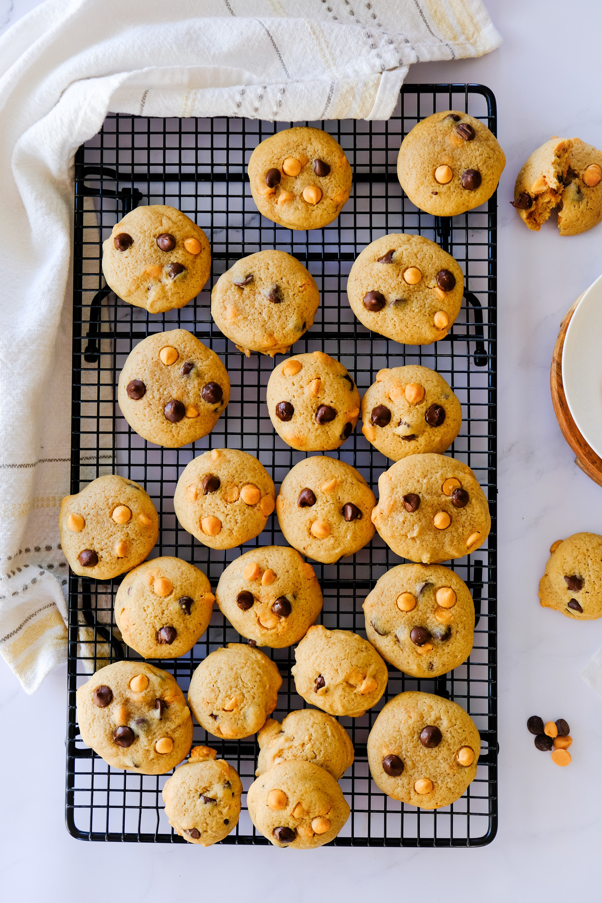 Overhead view of chocolate chip peanut butter chip cookies on a baking rack.