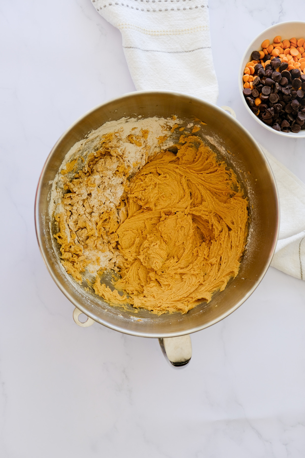 Wet and dry ingredients for cookie recipe in a mixing bowl.