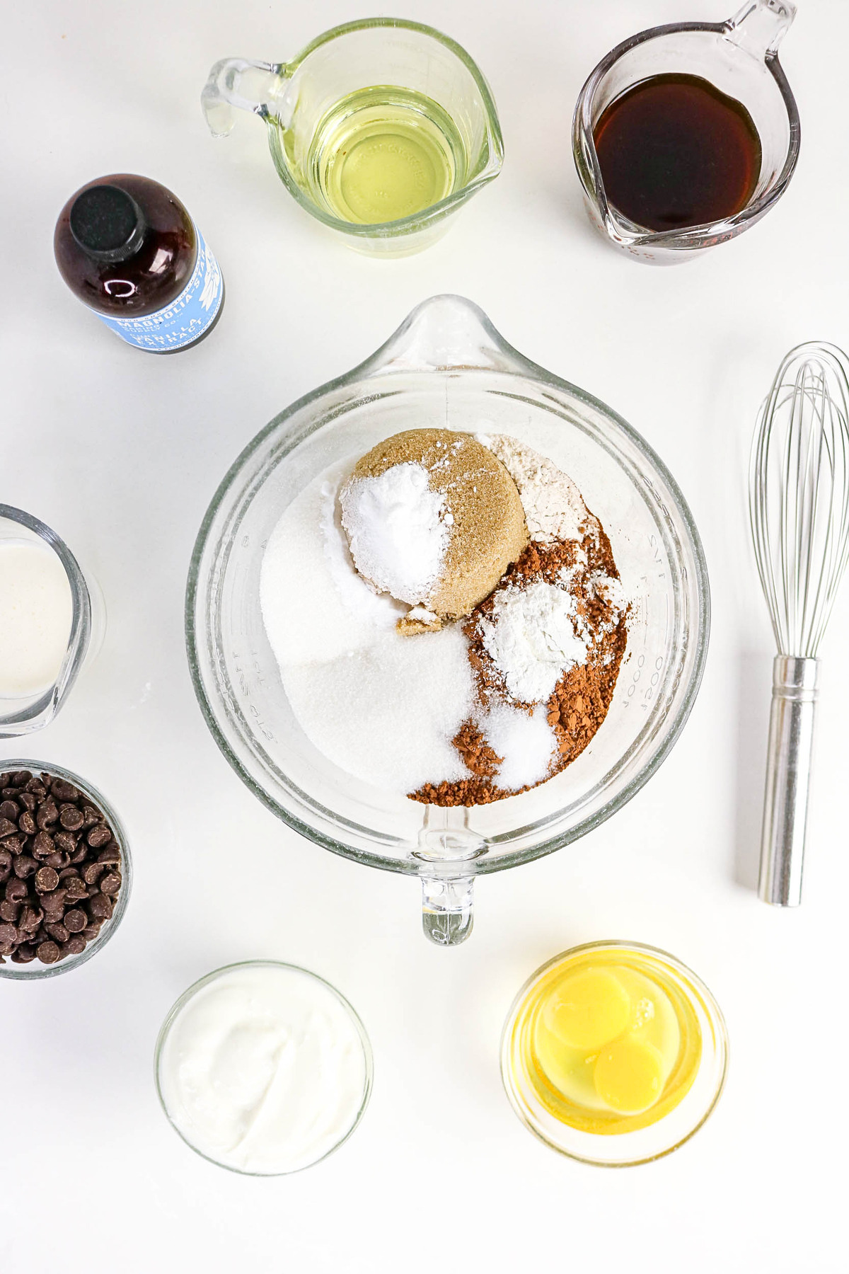 Dry ingredients for chocolate yogurt cake before whisking together in a clear mixing bowl.