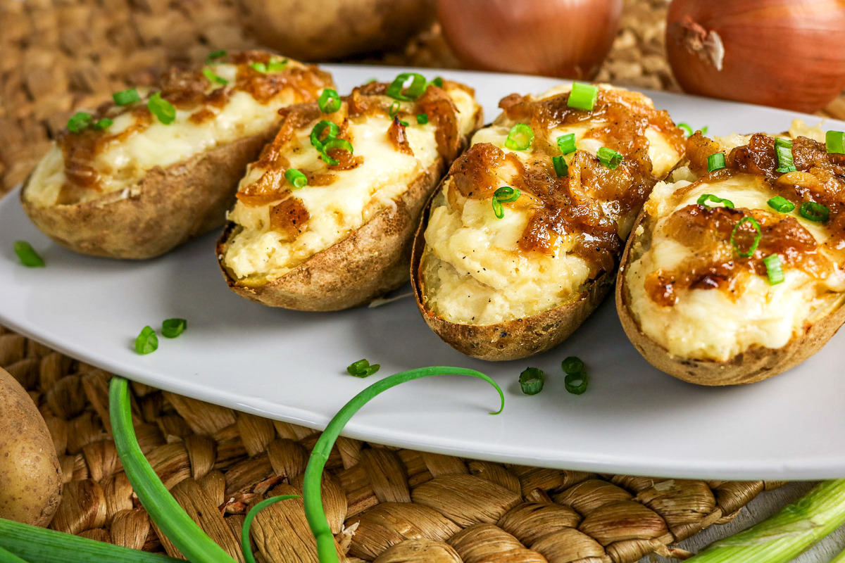 Baked potatoes topped with onion and green onions.
