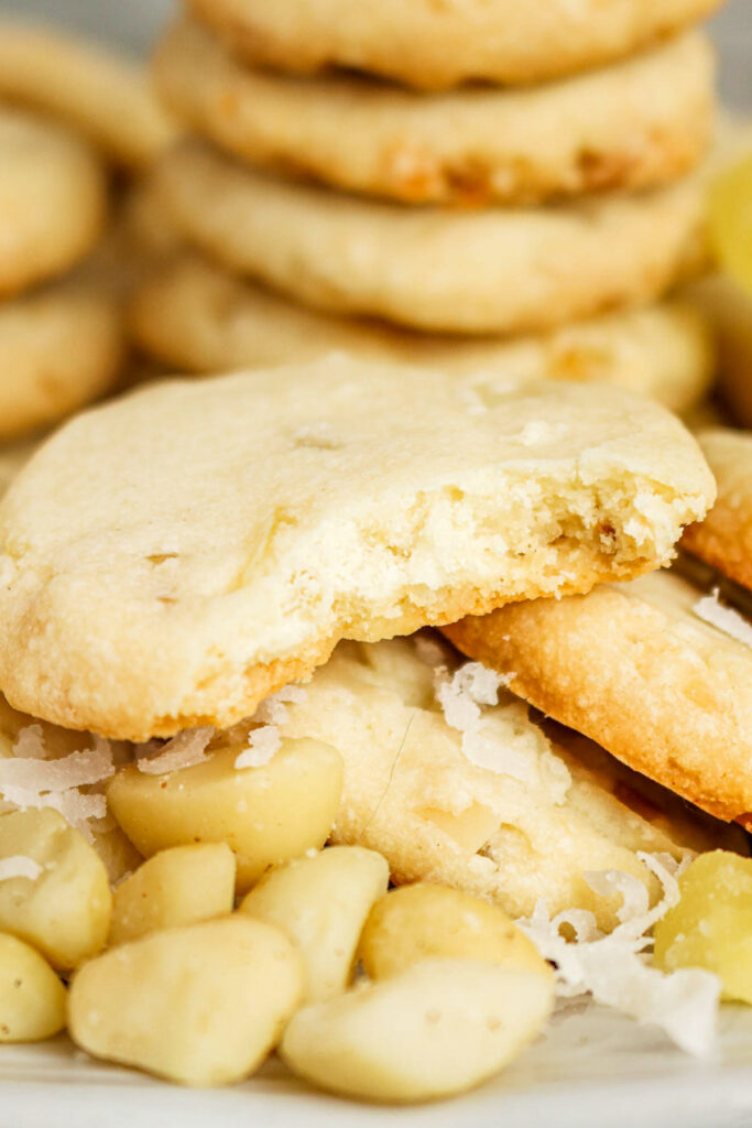 A stack of shortbread cookies with macadamia nuts on the side.