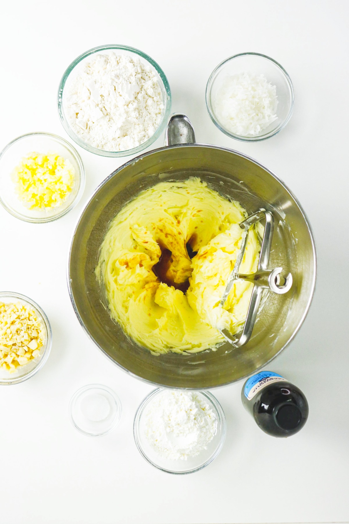 Creamed butter with vanilla extract in a stand mixing bowl.