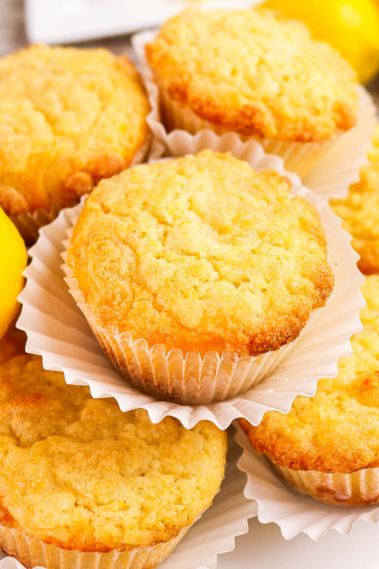 A plate piled with fresh baked lemon muffins.