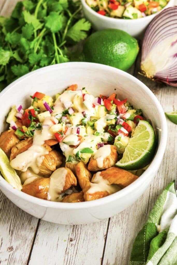 Pineapple chicken meal in a white bowl.