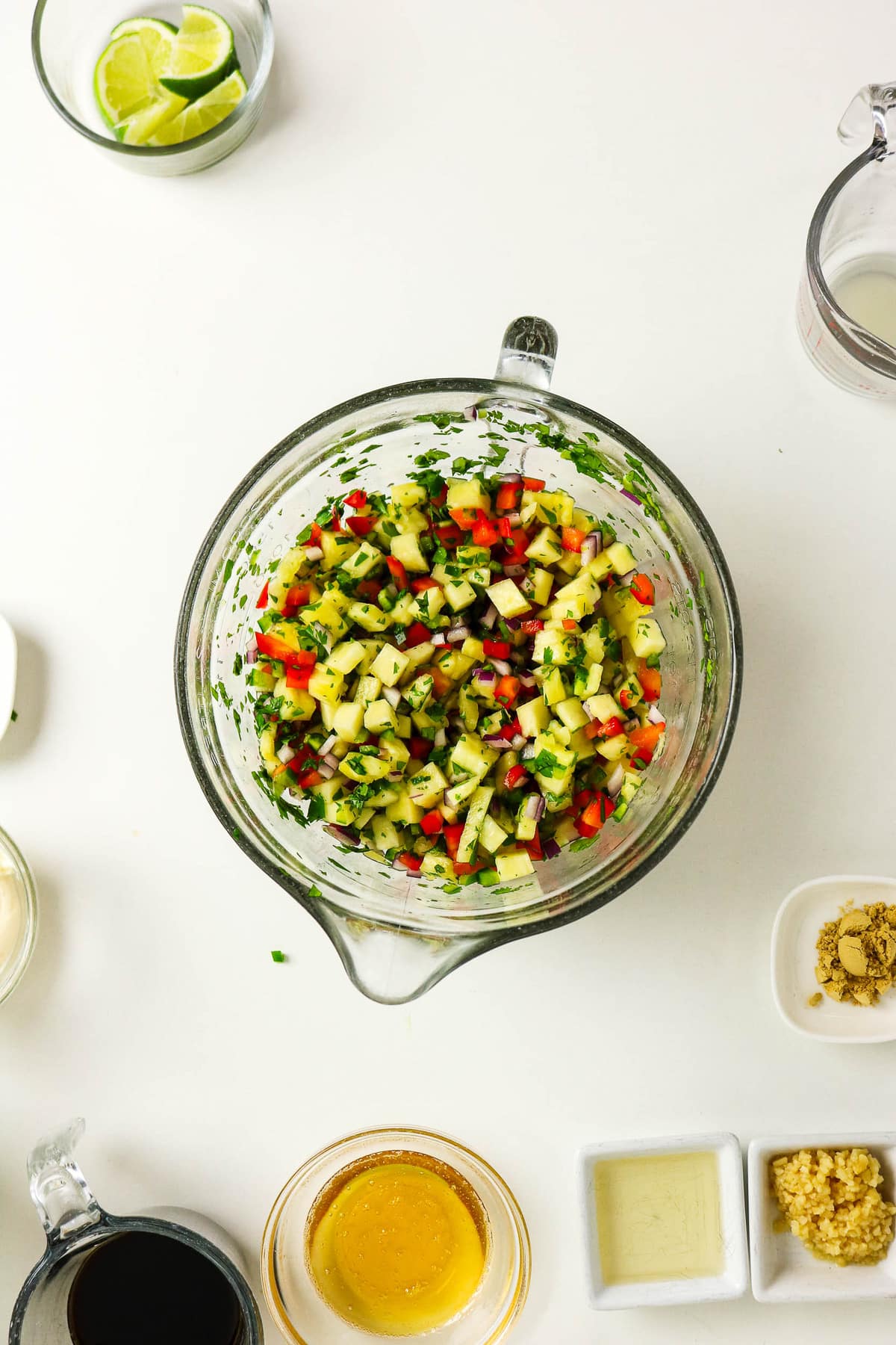 Pineapple salsa in a clear mixing bowl.