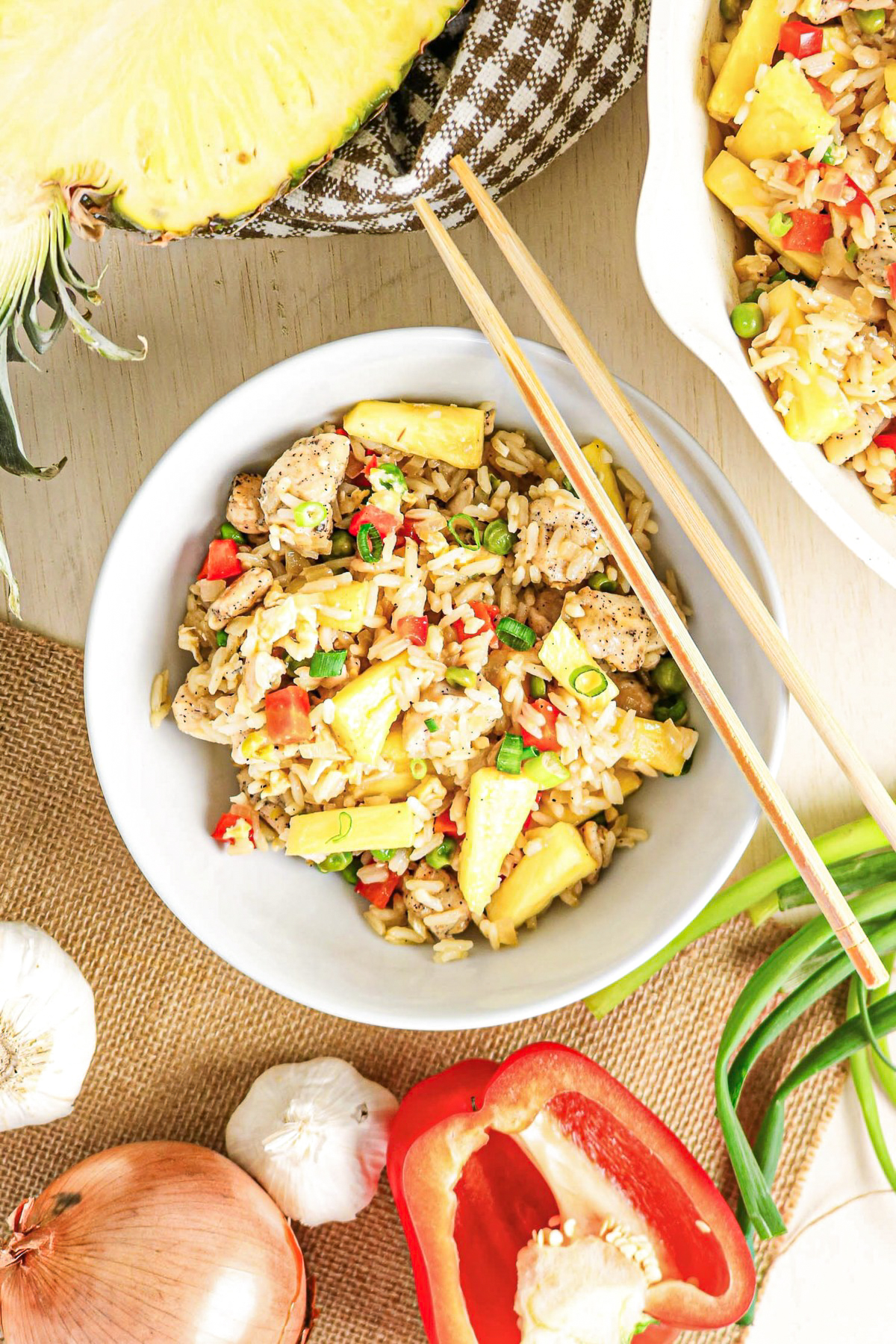 Top view of fried rice with chicken with red pepper and onion on the sice.