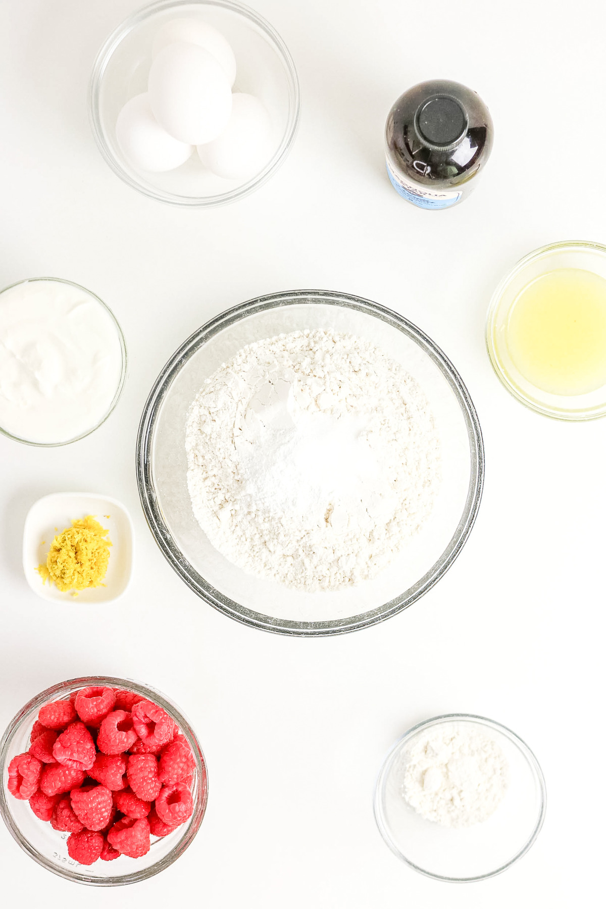 Top view of flour mixed with baking spices in a clear bowl.