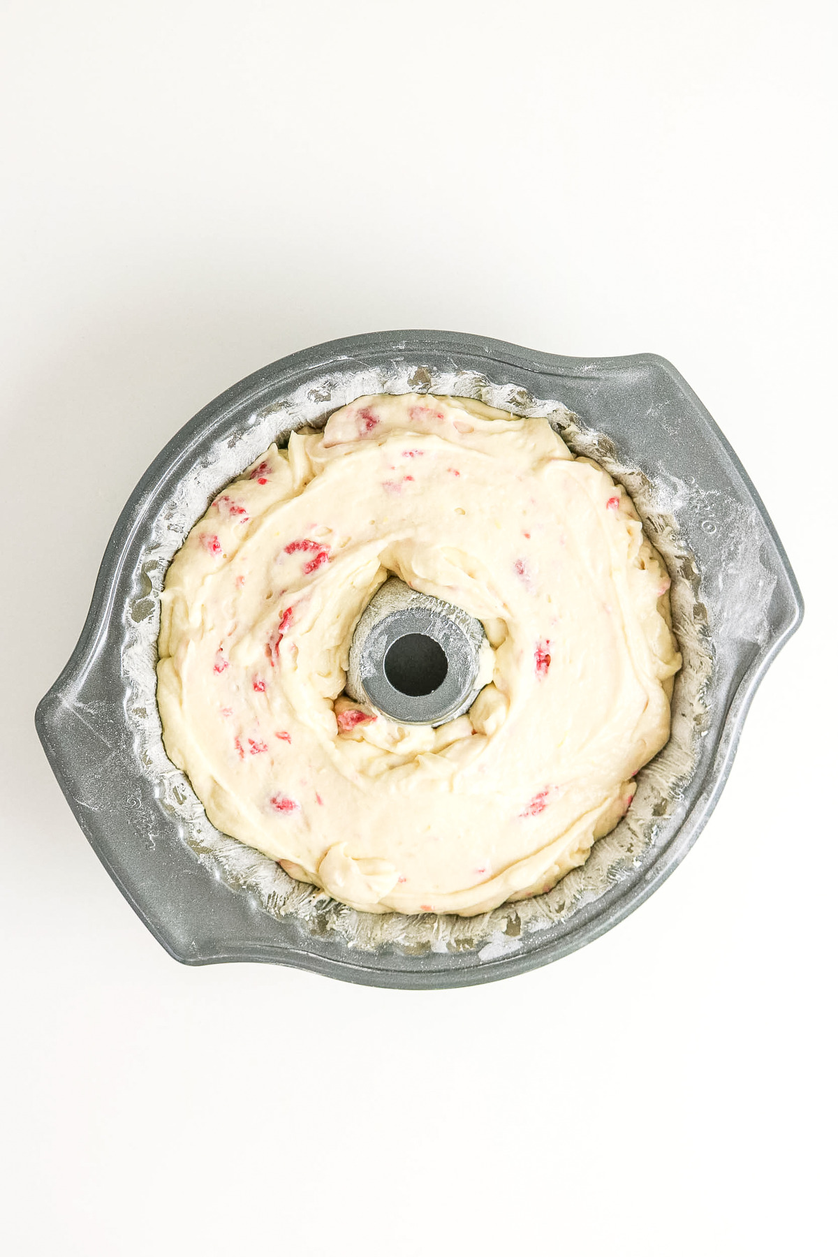 Cake batter placed in a bundt pan before baking.