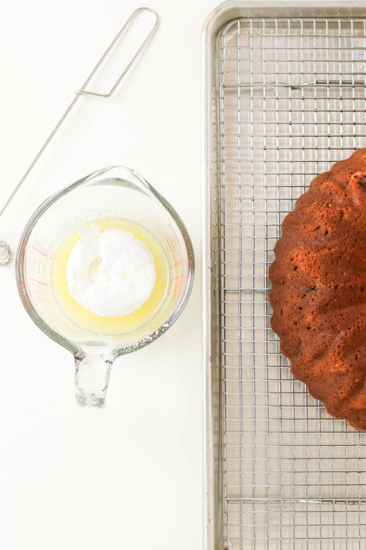 Powdered sugar in a measuring bowl with lemon juice before mixing into a glaze.