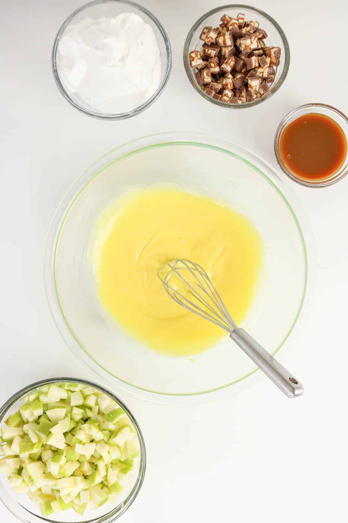 Lemon juice added to diced apple and milk mixed with pudding.