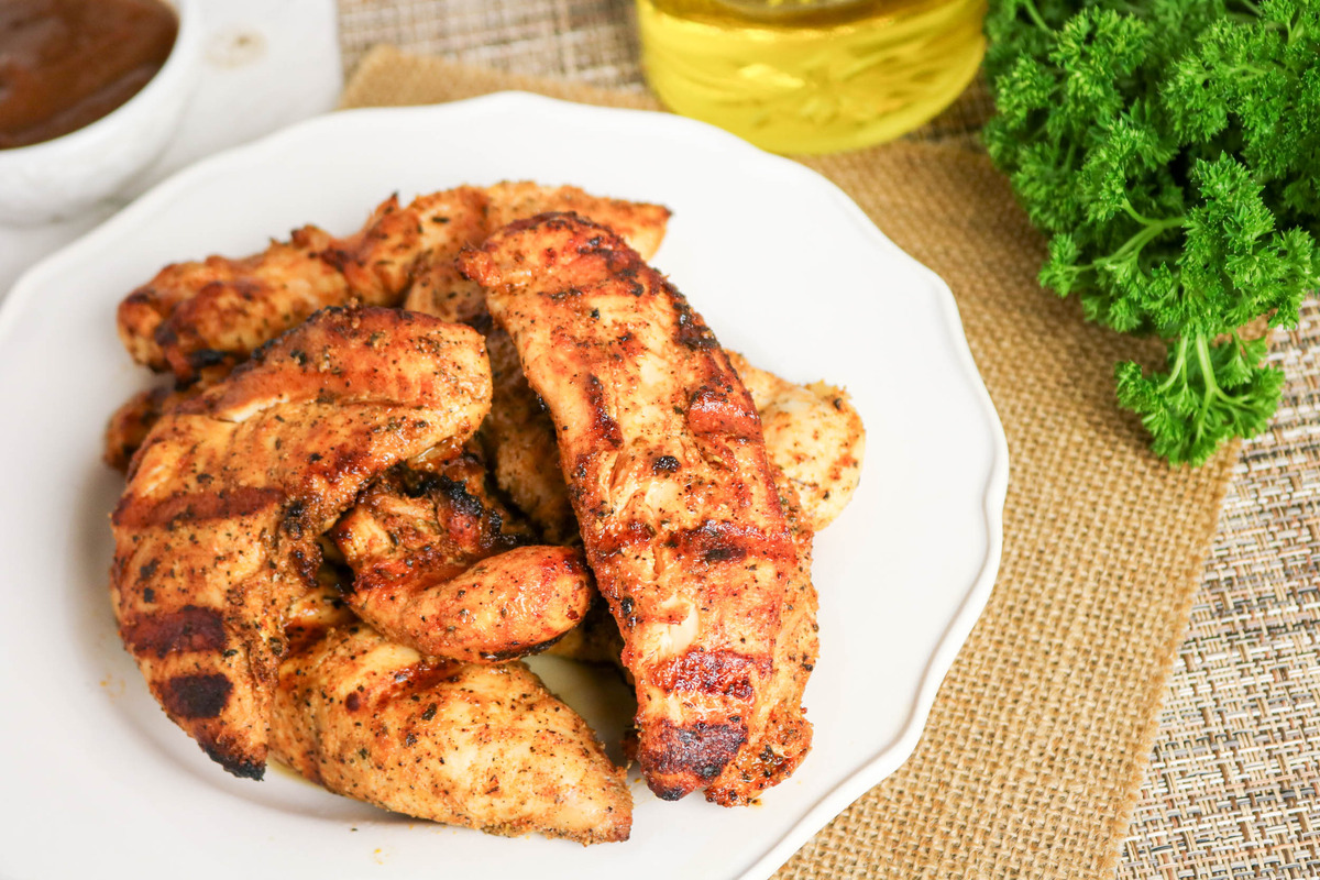 Grilled Chicken tenderloins on a white serving dish ready to enjoy.