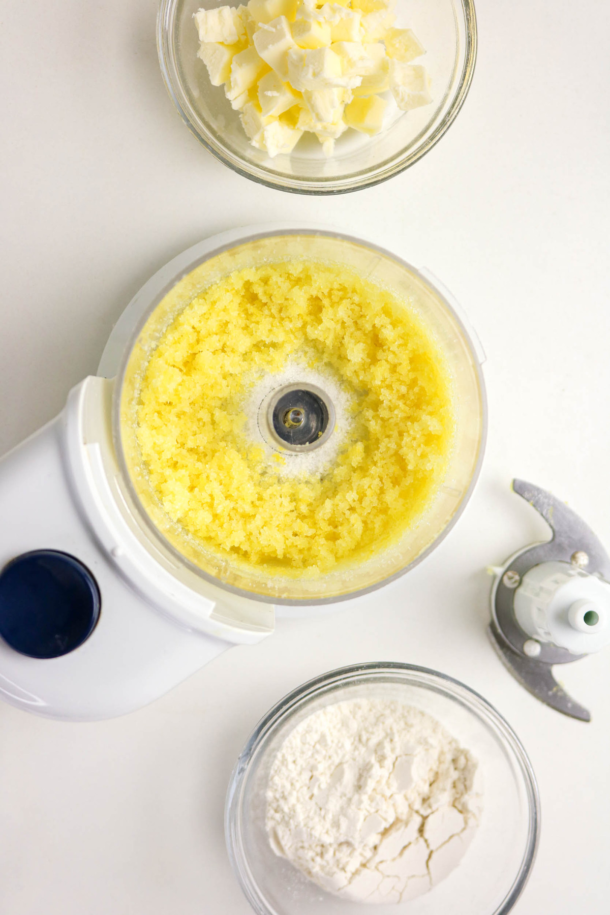 In a food process lemon rind with sugar blended together.