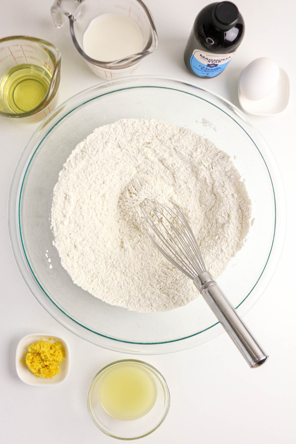 Dry flour ingredients to make muffins in a clear mixing bowl.