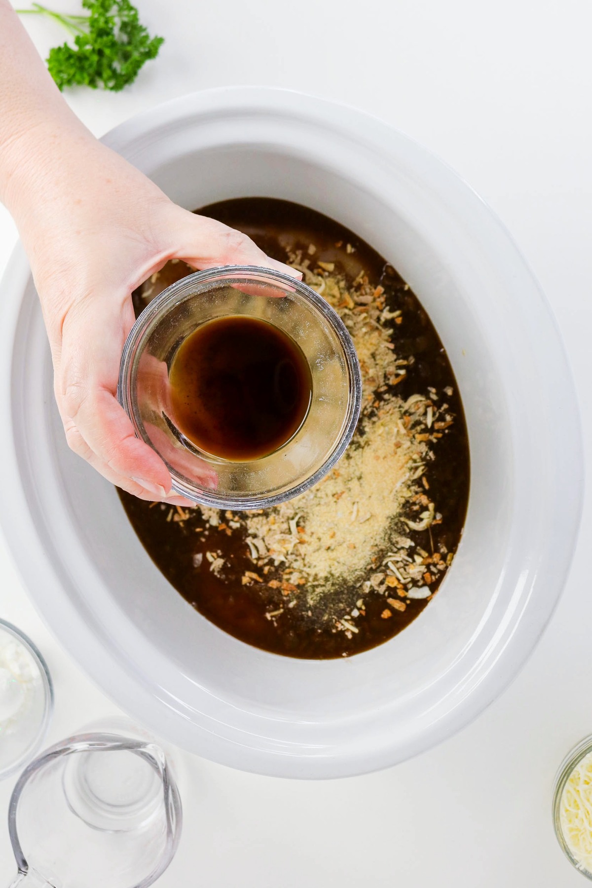 Spices added to slow cooker before cooking chicken.