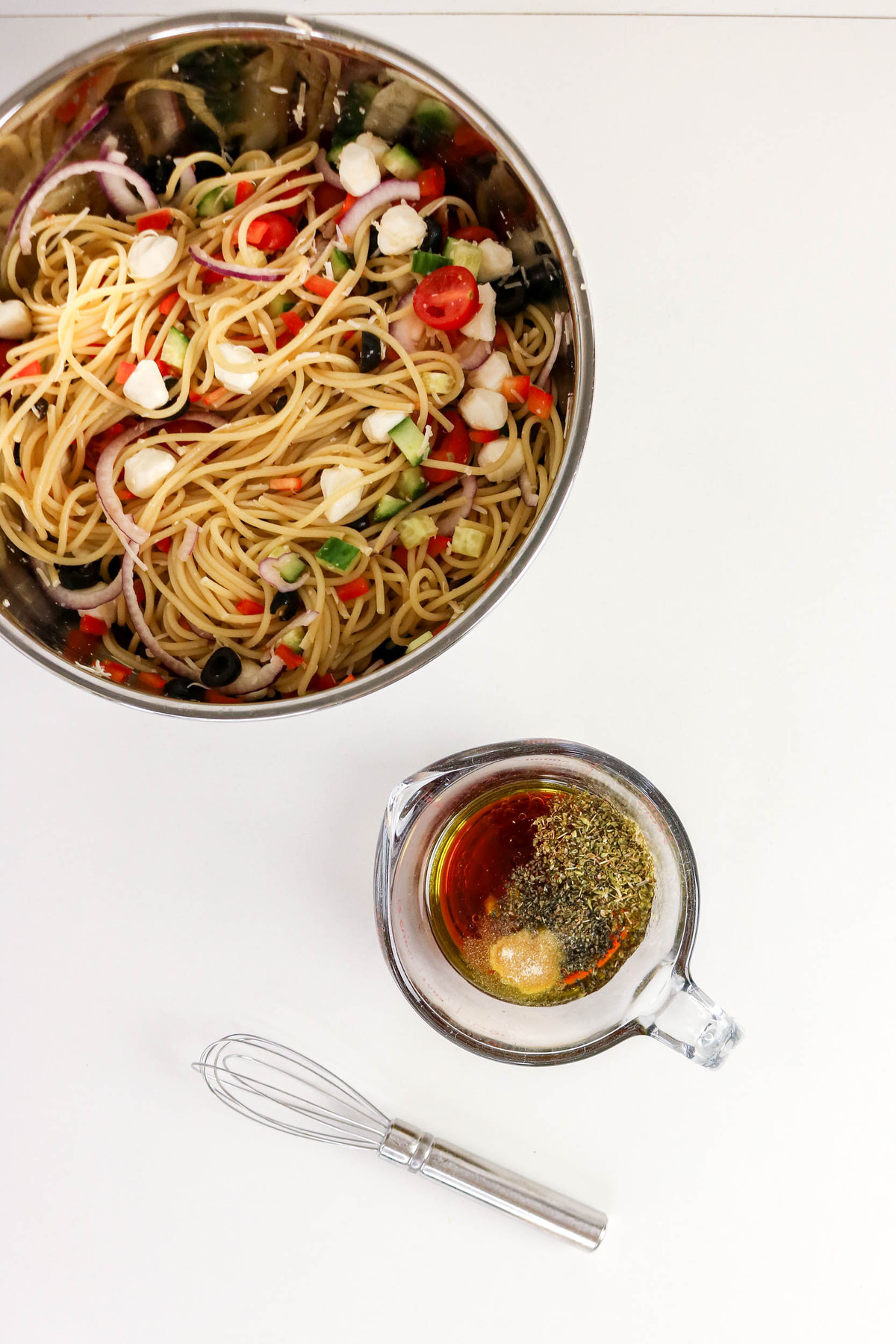 Homemade Italian dressing in a glass measuring cup.