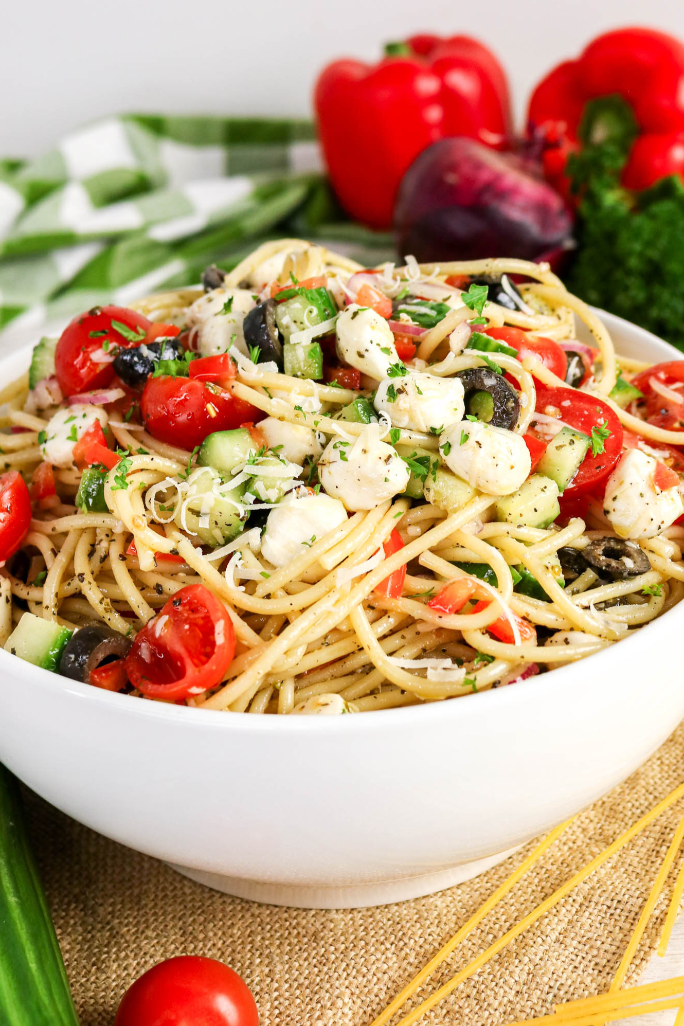Spaghetti pasta salad in a white mixing bowl.