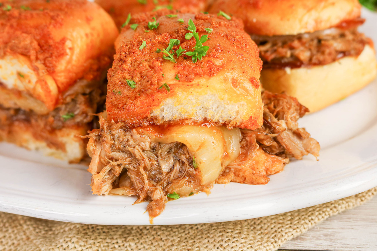 A slider sandwich with pulled pork on a plate ready to serve.