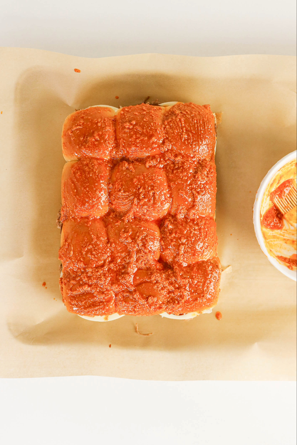 Butter mix over slider Hawaiian rolls before baking.