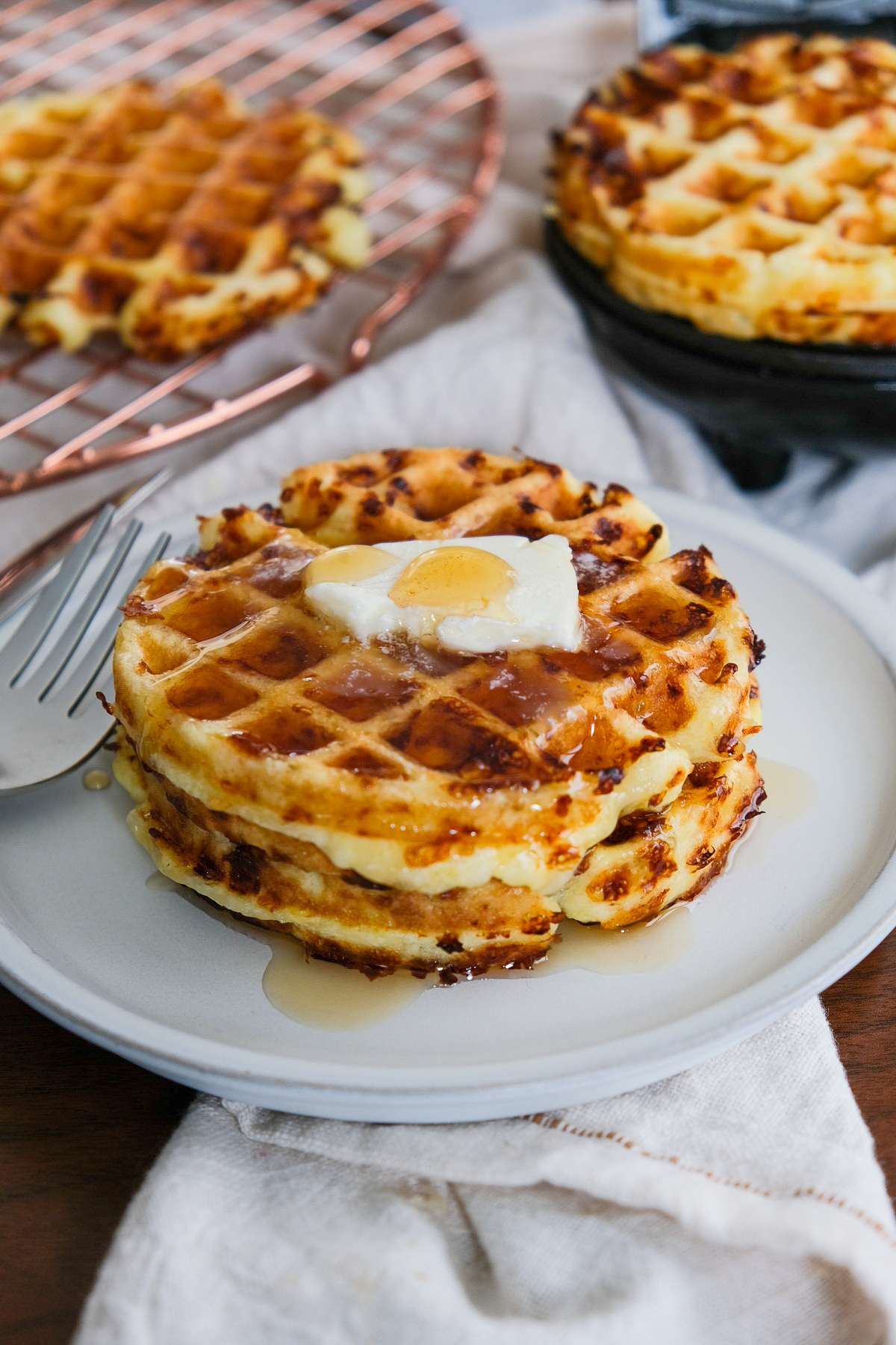 Two chaffles topped with butter and maple syrup.