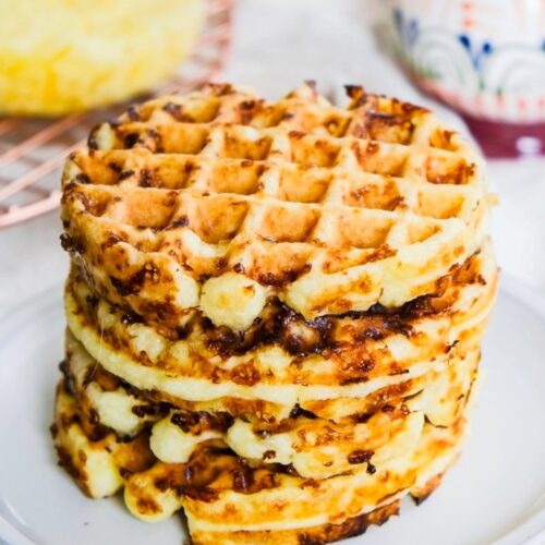 A stack of chaffles on a white plate.