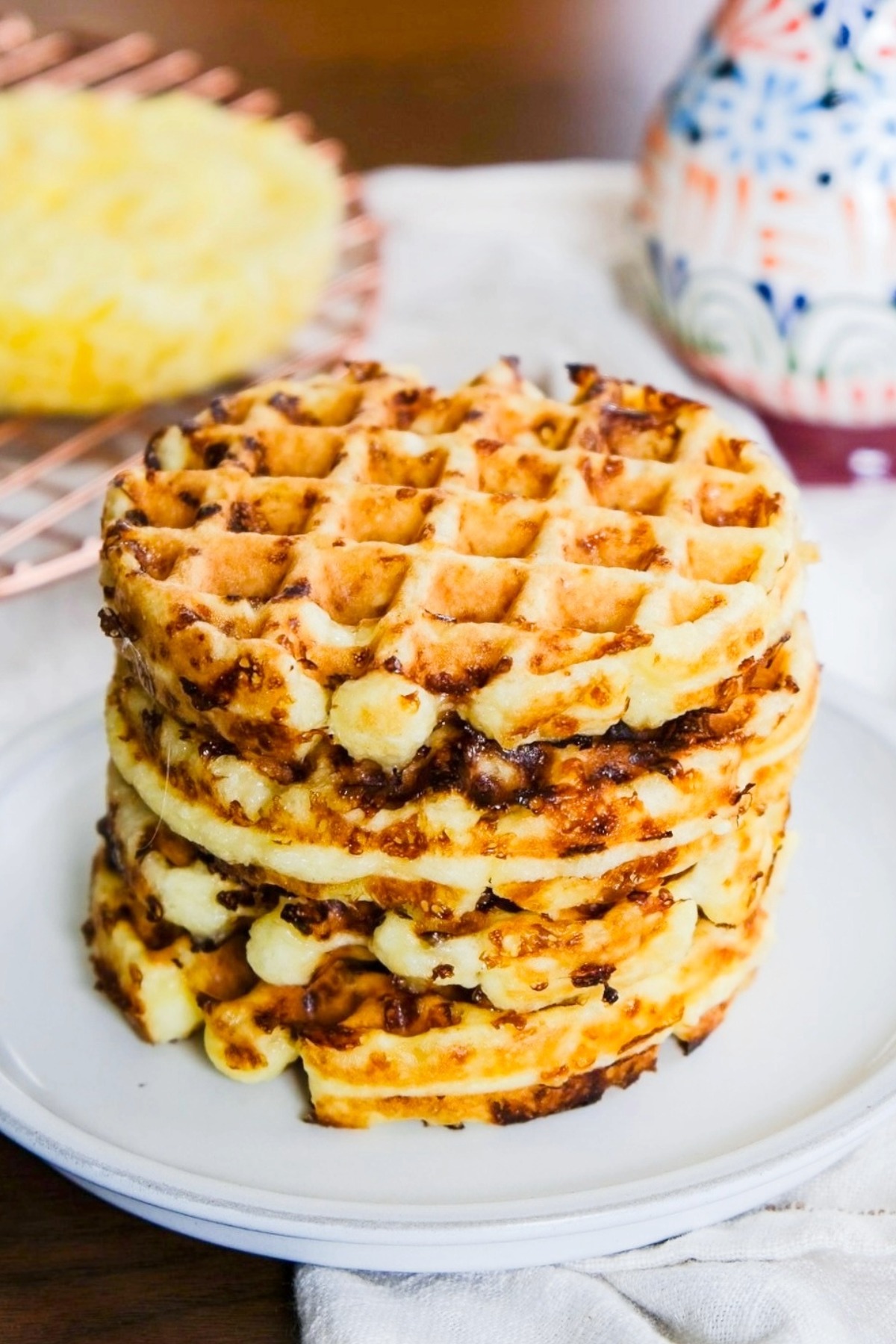 A stack of chaffles on a white plate.