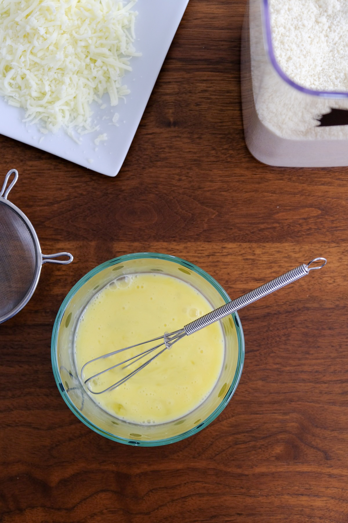 Egg whisked in a small clear mixing bowl.