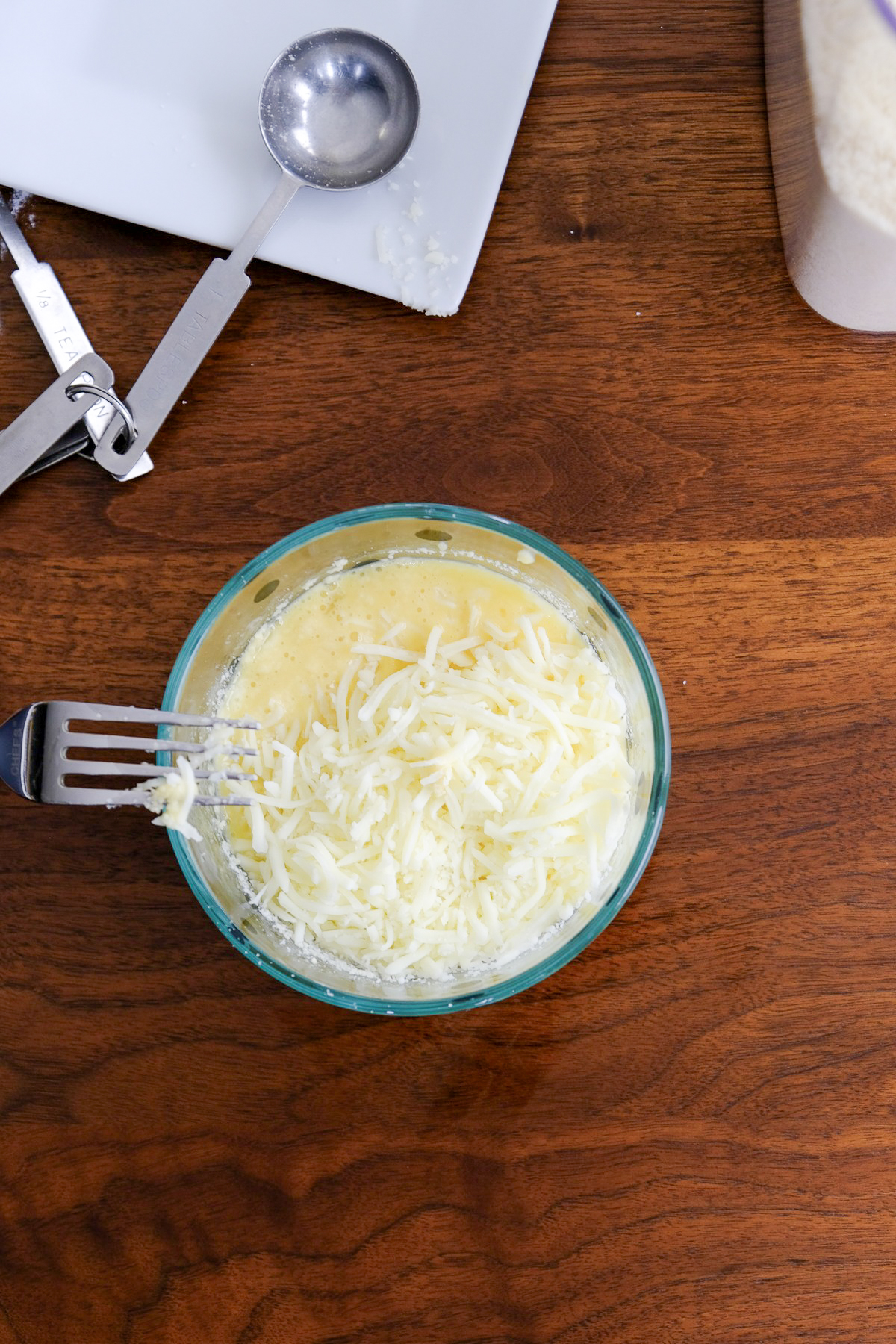 Shredded mozzarella cheese folded into egg mixture.