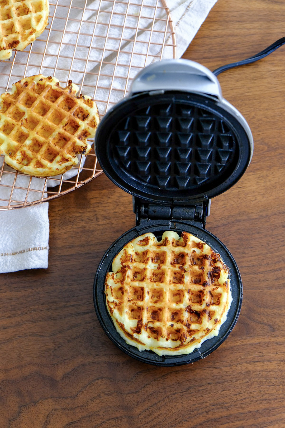 Cooked chaffle in a mini waffle maker.