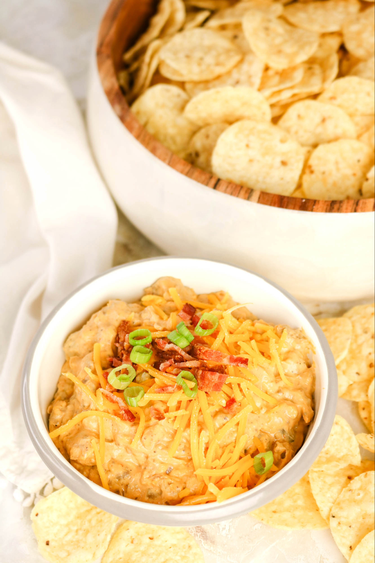 Tortilla chips surrounded by cheesy cheeseburger dip.