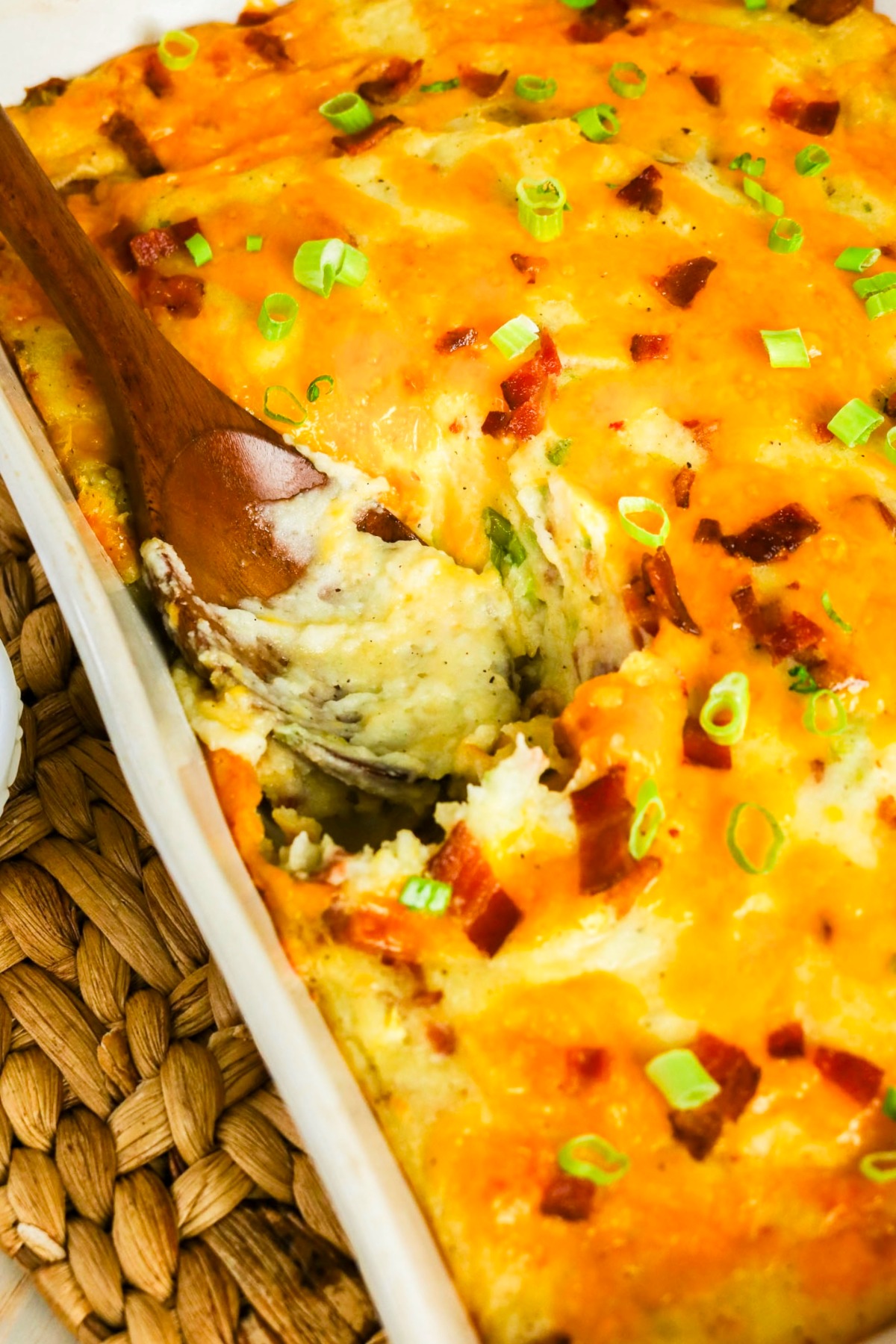 casserole of mashed potatoes with melted cheese in a white baking dish.
