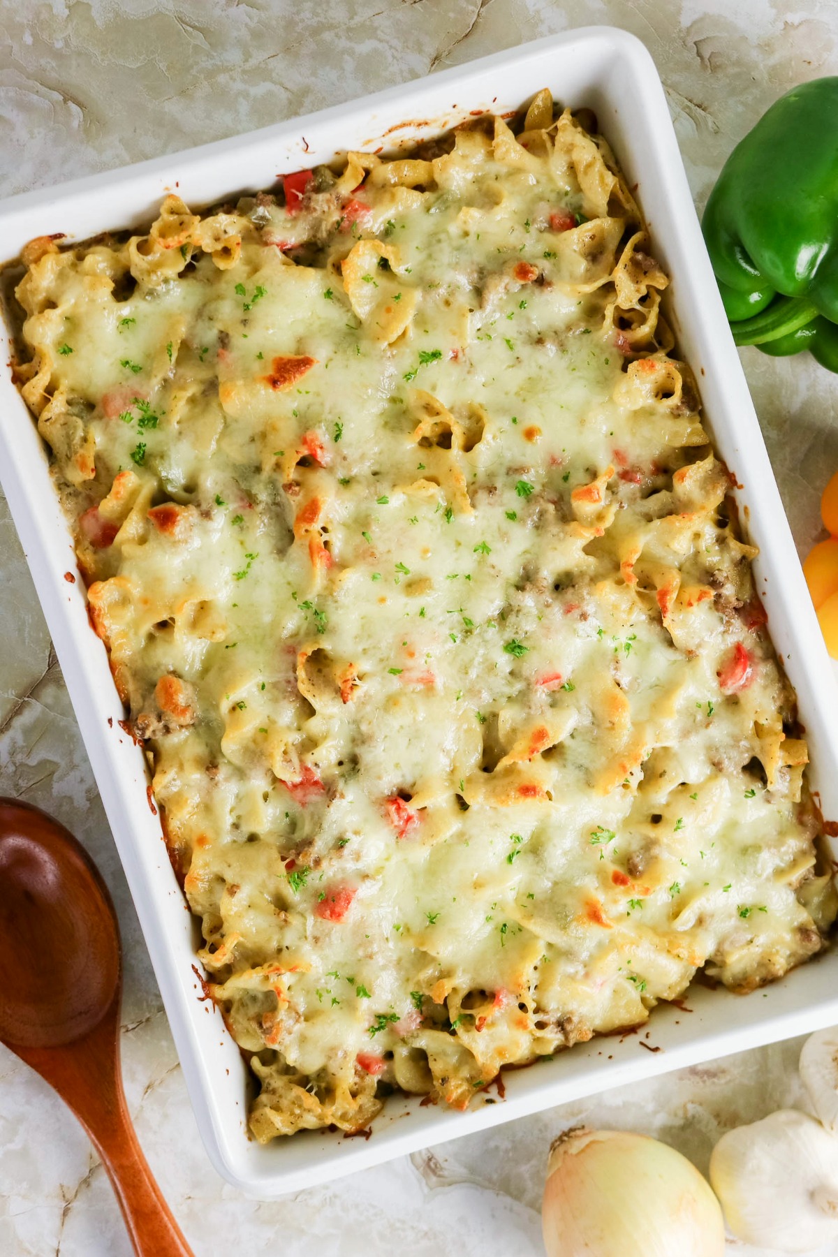 Overhead view of baked Philly cheesesteak casserole in a white baking dish.