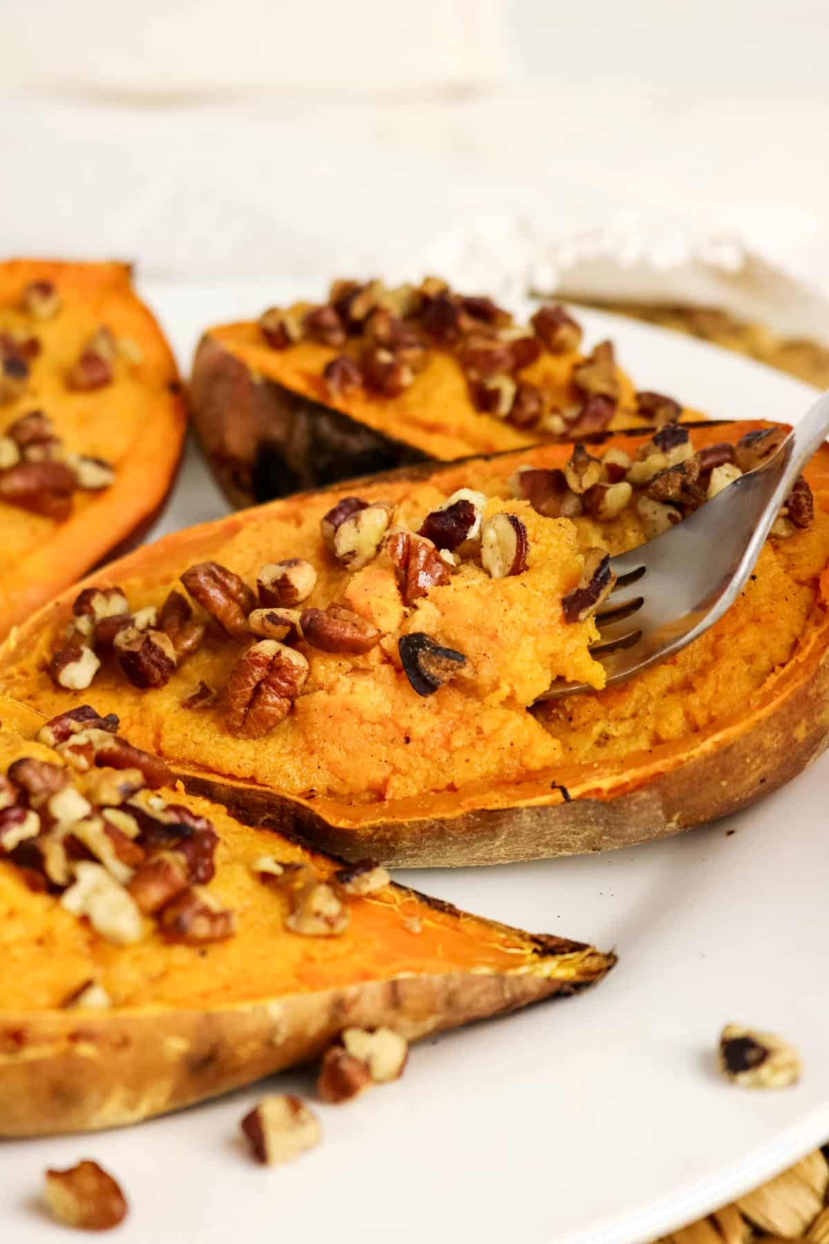Twice baked sweet potatoes on a white serving plate.