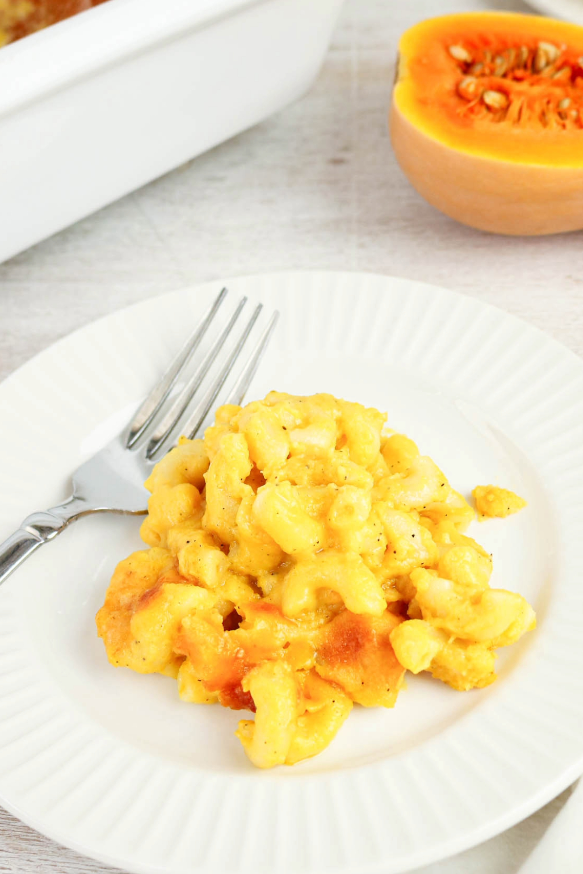 A white plate full of butternut macaroni and cheese.
