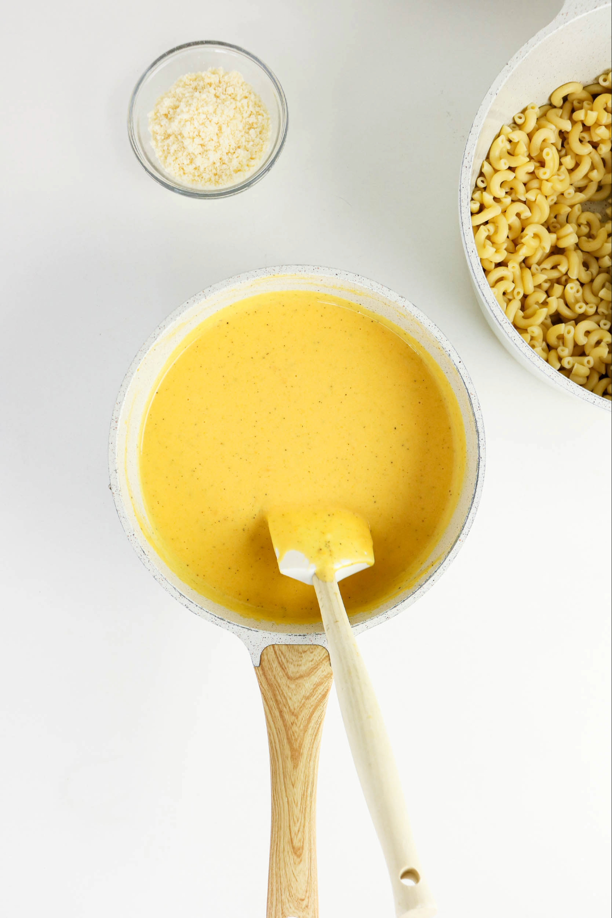 Sauce with cheese, milk and butternut squash in a skillet.