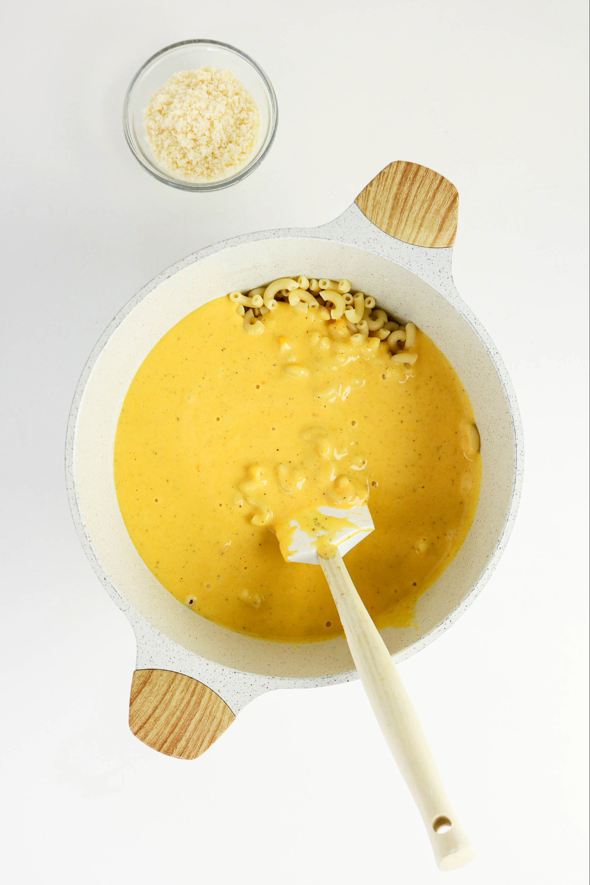 Mac and cheese sauce mix in a stock pan with cooked macaroni.