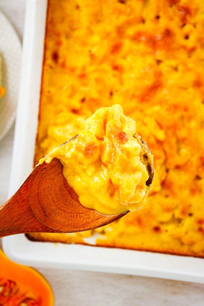 Macaroni and cheese made with butternut squash in a white baking dish.