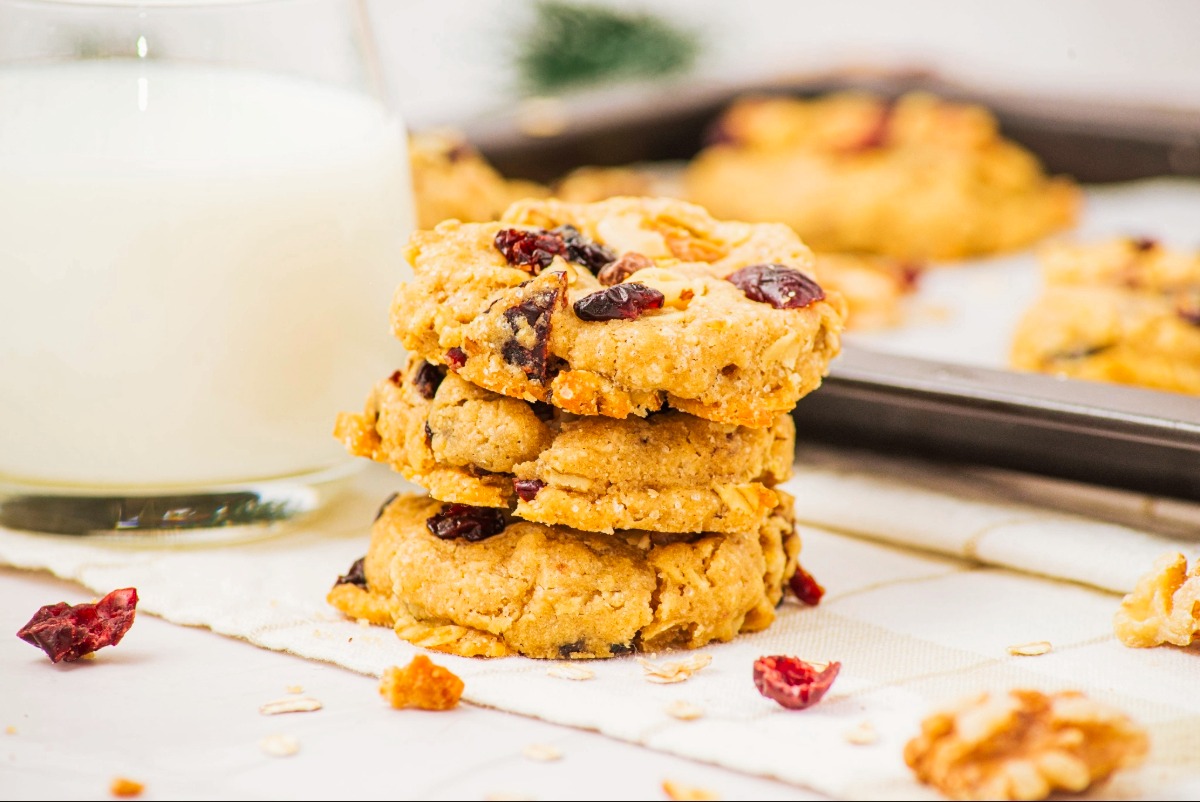 A stack of cranberry oatmeal cookies with a cookie sheet in the background.