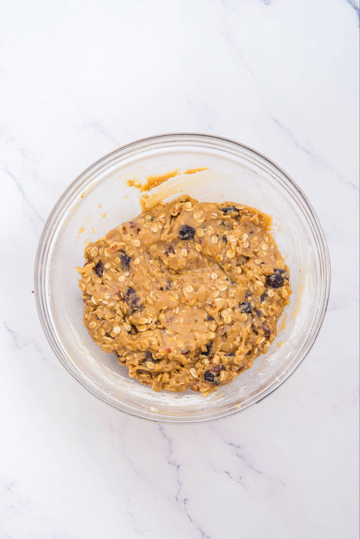 Mixed cookie dough in a clear mixing bowl.
