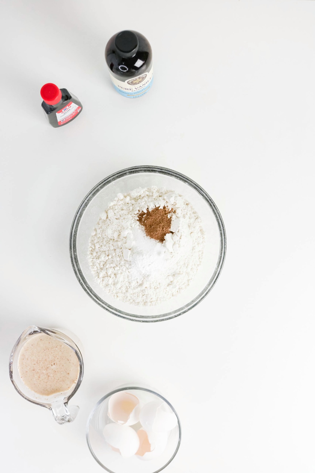 Dry ingredients in a clear mixing bowl before whisking.