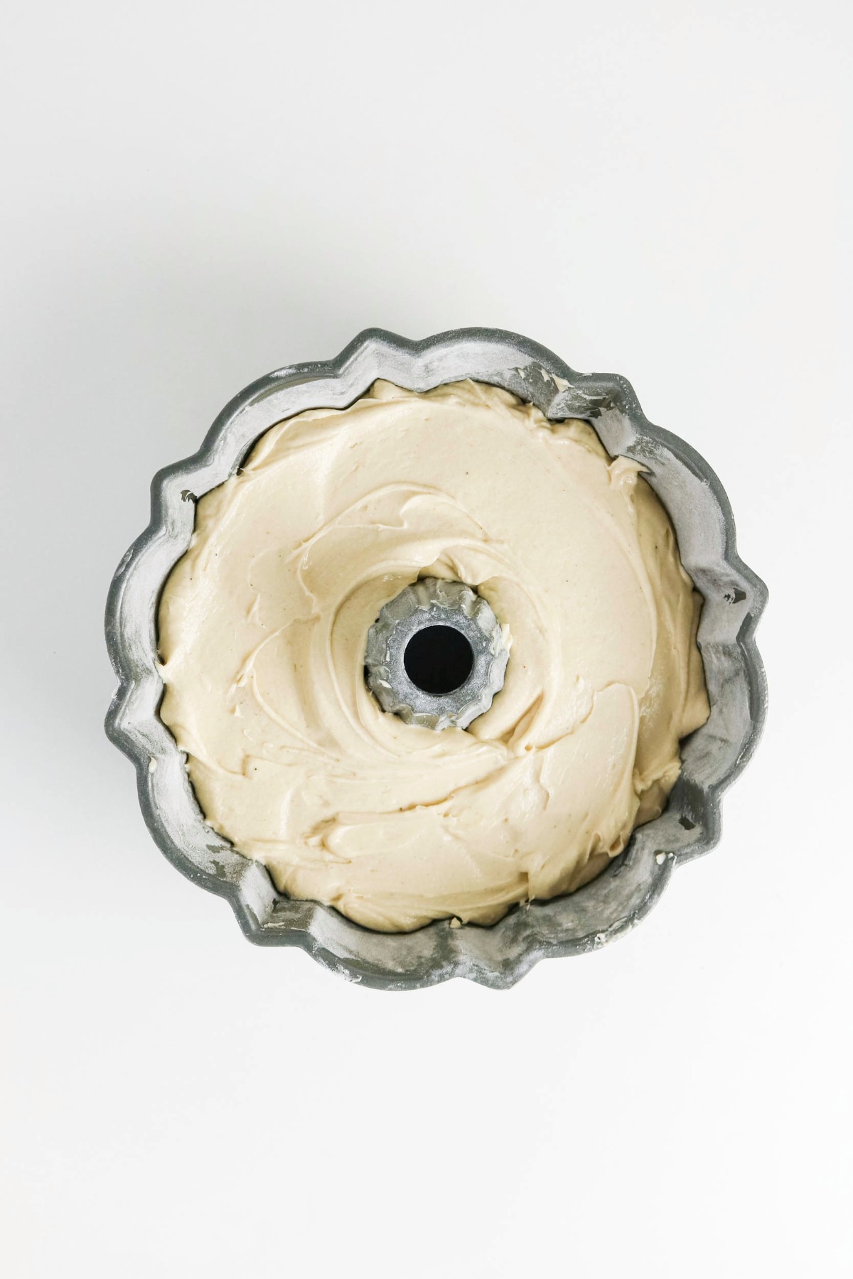 Batter poured into a floured and greased bundt pan before baking.